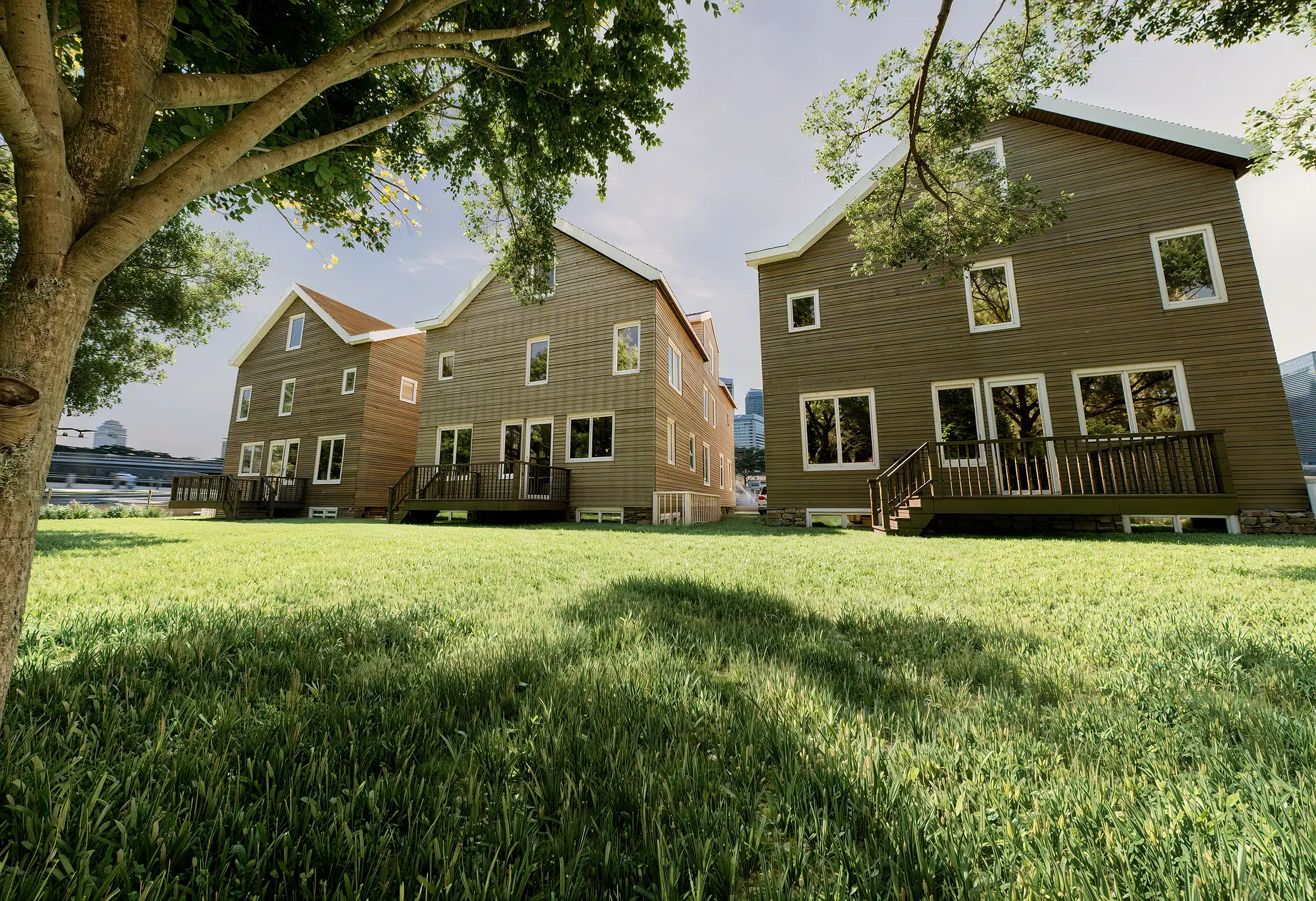 Side-perspective view of three neighboring modern shingle-style houses in Far Rockaway